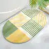Dywanik łazienkowy owalny w geometryczne pasy
